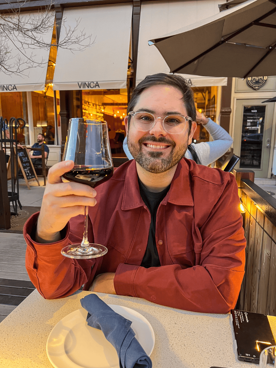 Joey holding up his glass of Bordeaux Château de Pez at Vinca in Boulder, Colorado