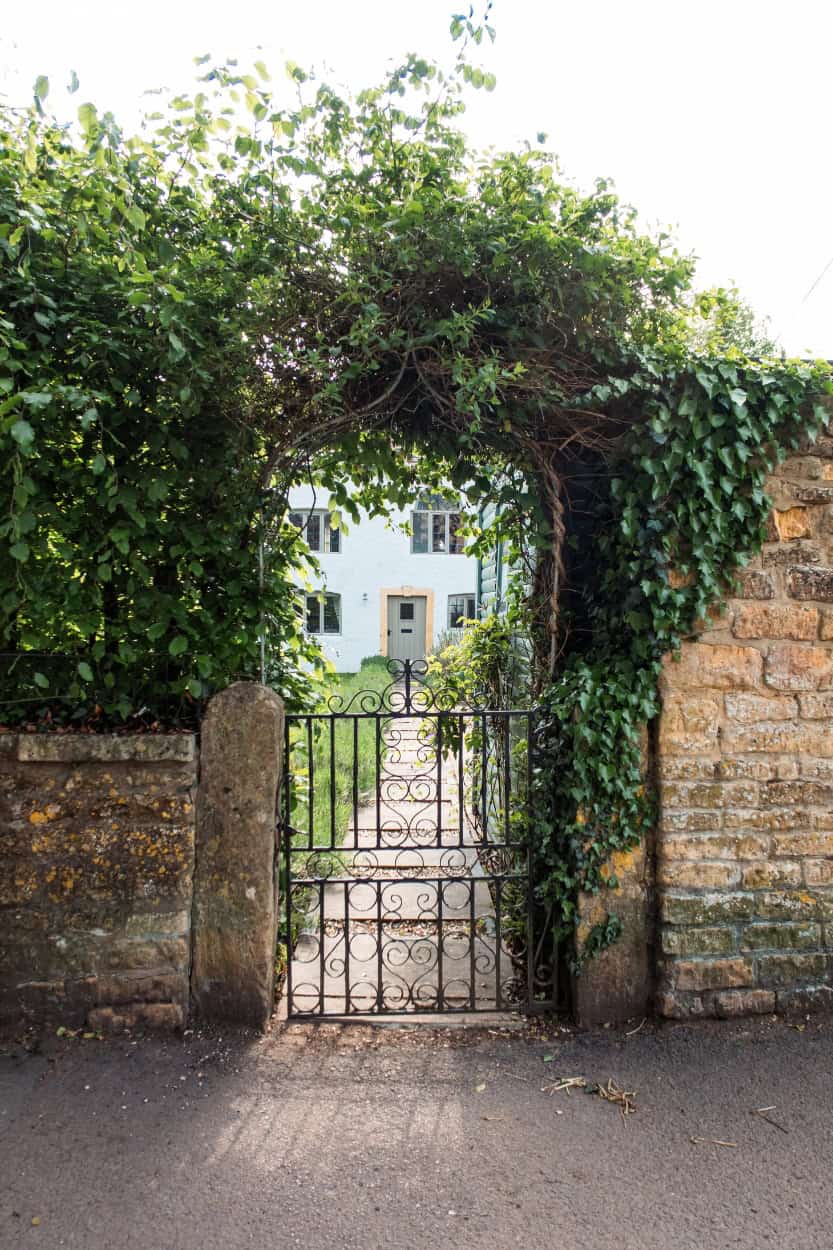 Wrought iron gate covered in vines walking the Cotswolds England