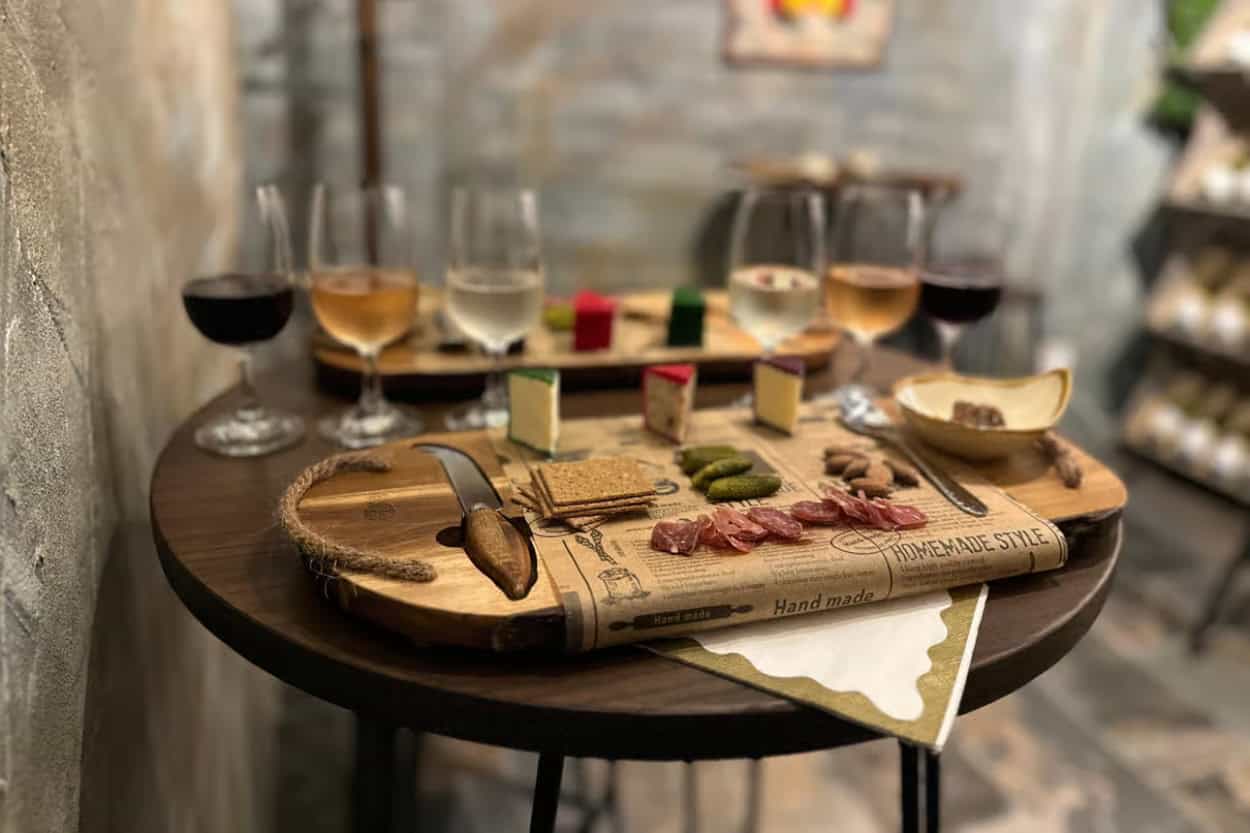 Wine, cheese, and pickles laid out for a tasting at Cork and Truckle in Bath
