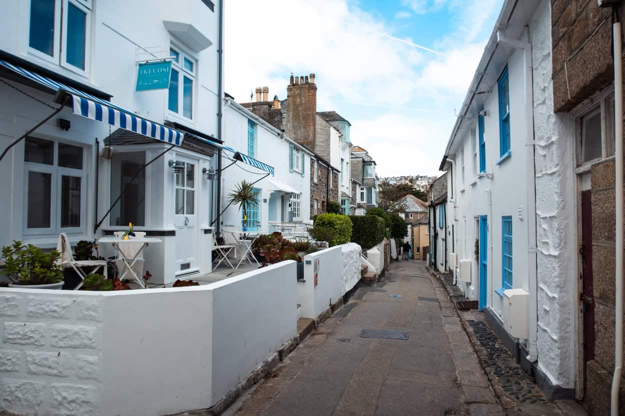 A charming narrow alley lined with stone buildings in St. Ives, England