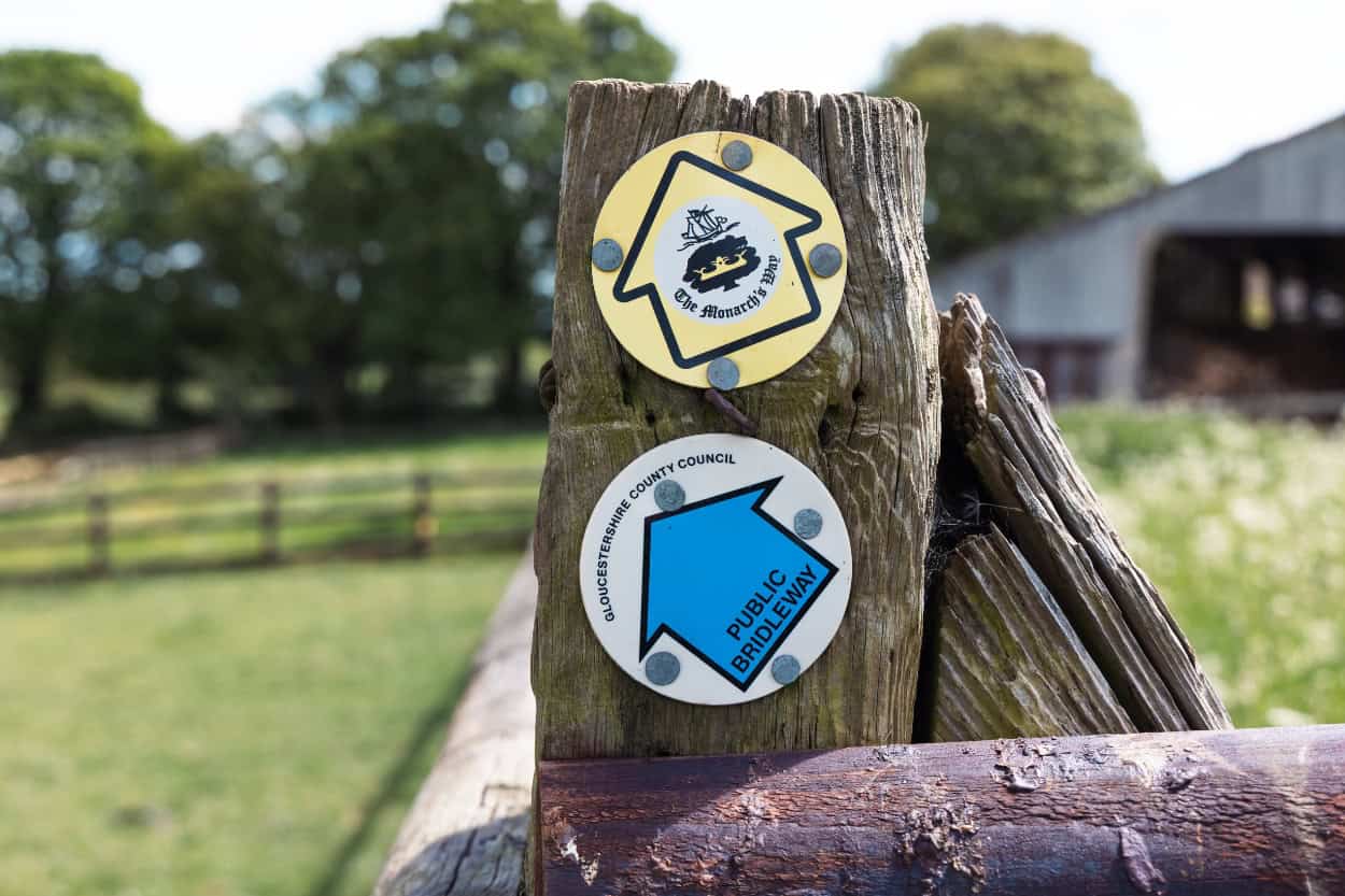 Monarch's Way and Public Bridleway signpost walking the Cotswolds countryside England