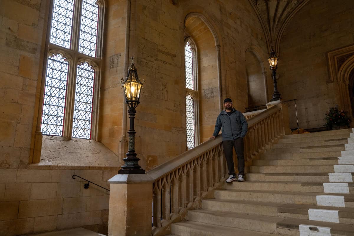 oey standing alone on the Hall Stairs at Christ Church College Oxford