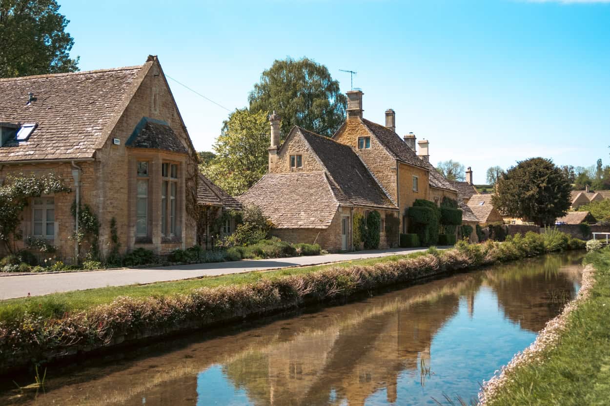 Stone cottages along the creek in Lower Slaughter walking the Cotswolds England