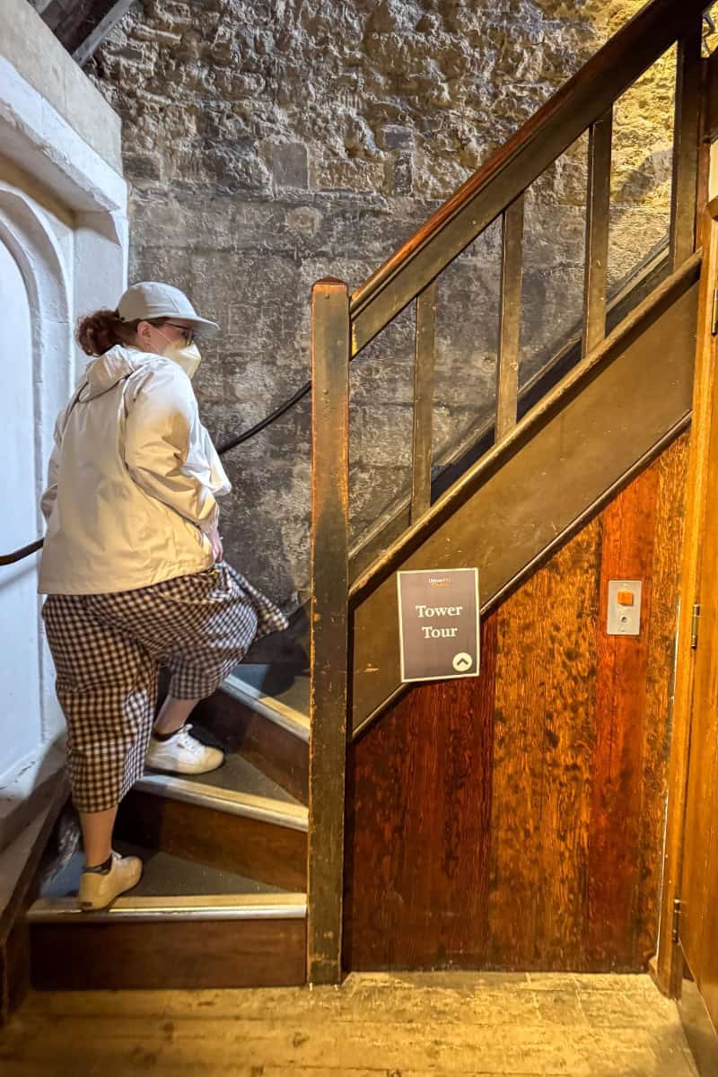 Katie climbing the narrow spiral staircase inside St Mary's Church Tower Oxford
