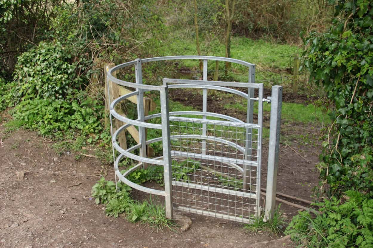 Close up of a wooden kissing gate walking the Cotswolds countryside England