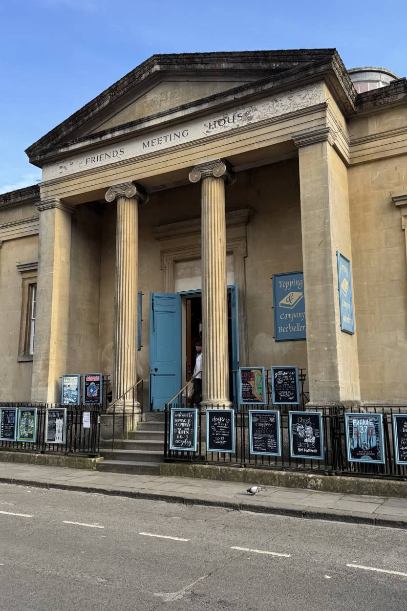 Exterior of Topping & Company Booksellers in Bath, England, with signage out front