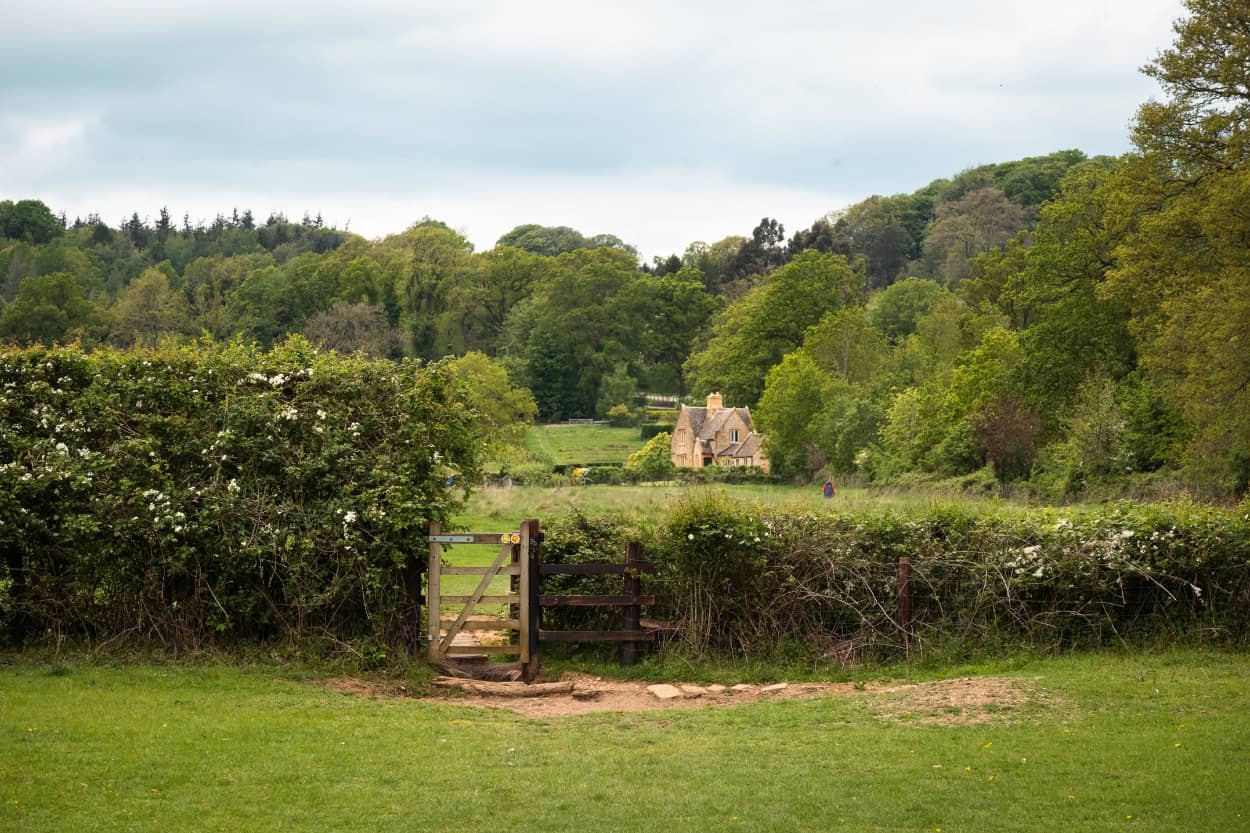 A traditional kissing gate along a walking path in the Cotswolds, England