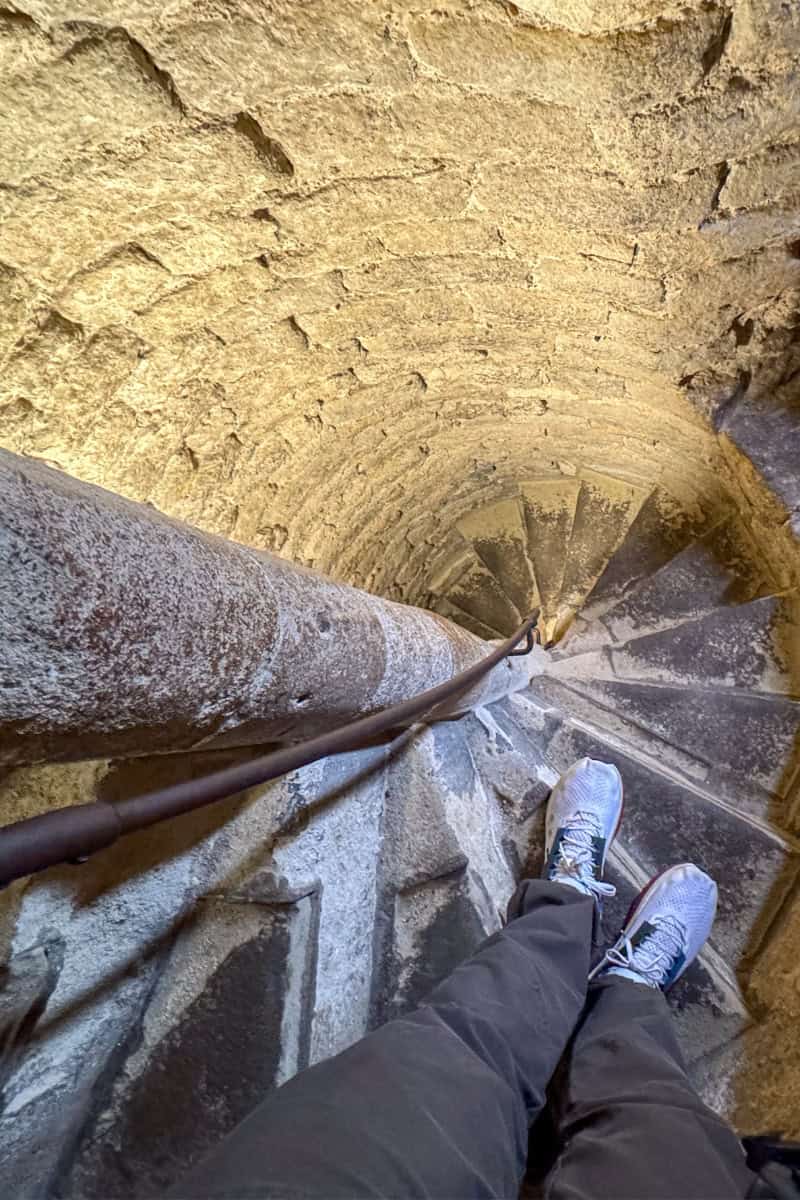 Joey descending the steep spiral staircase inside St Mary's Church Tower Oxford