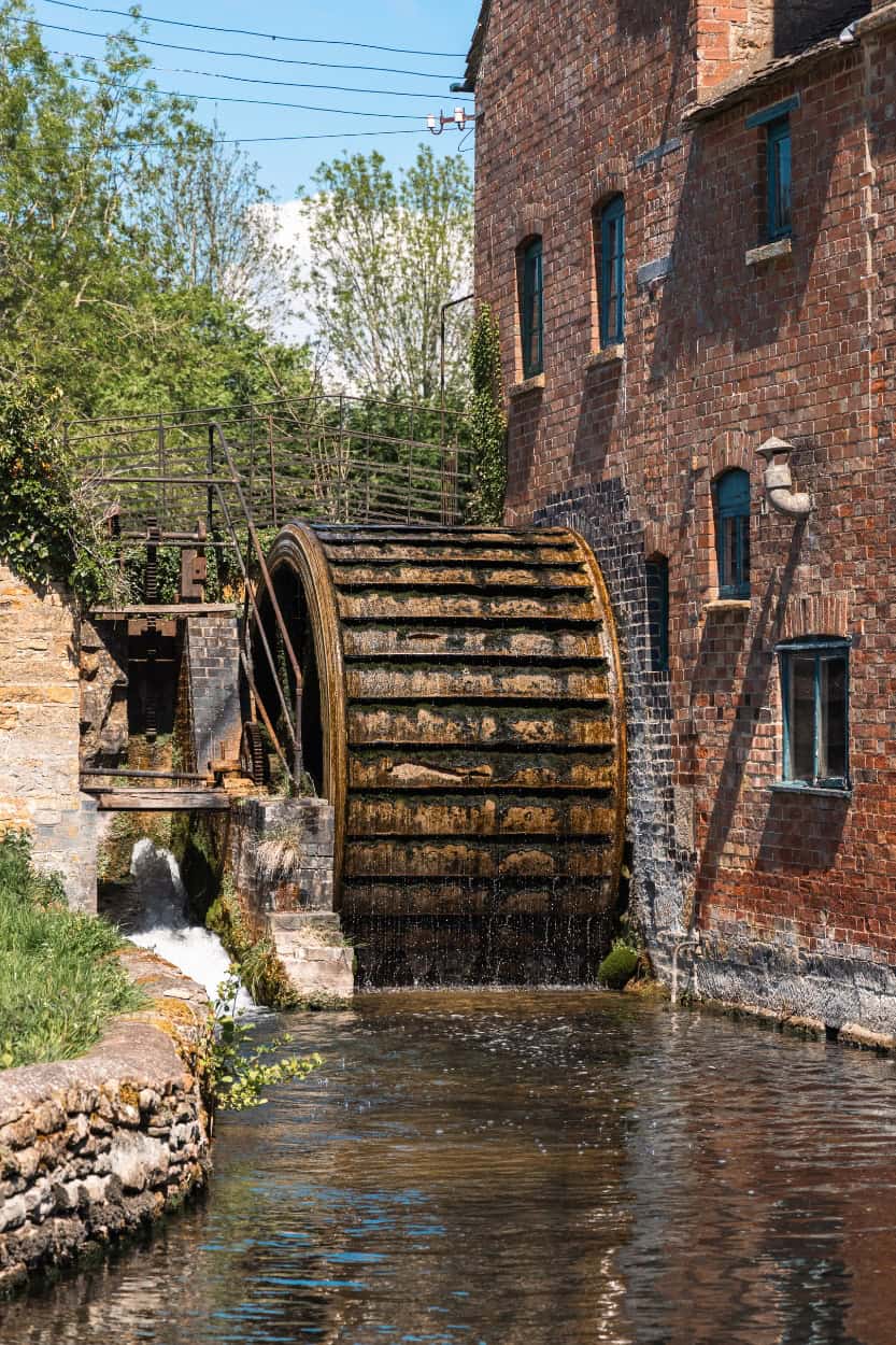 Old mill water wheel in motion walking the Cotswolds in Lower Slaughter