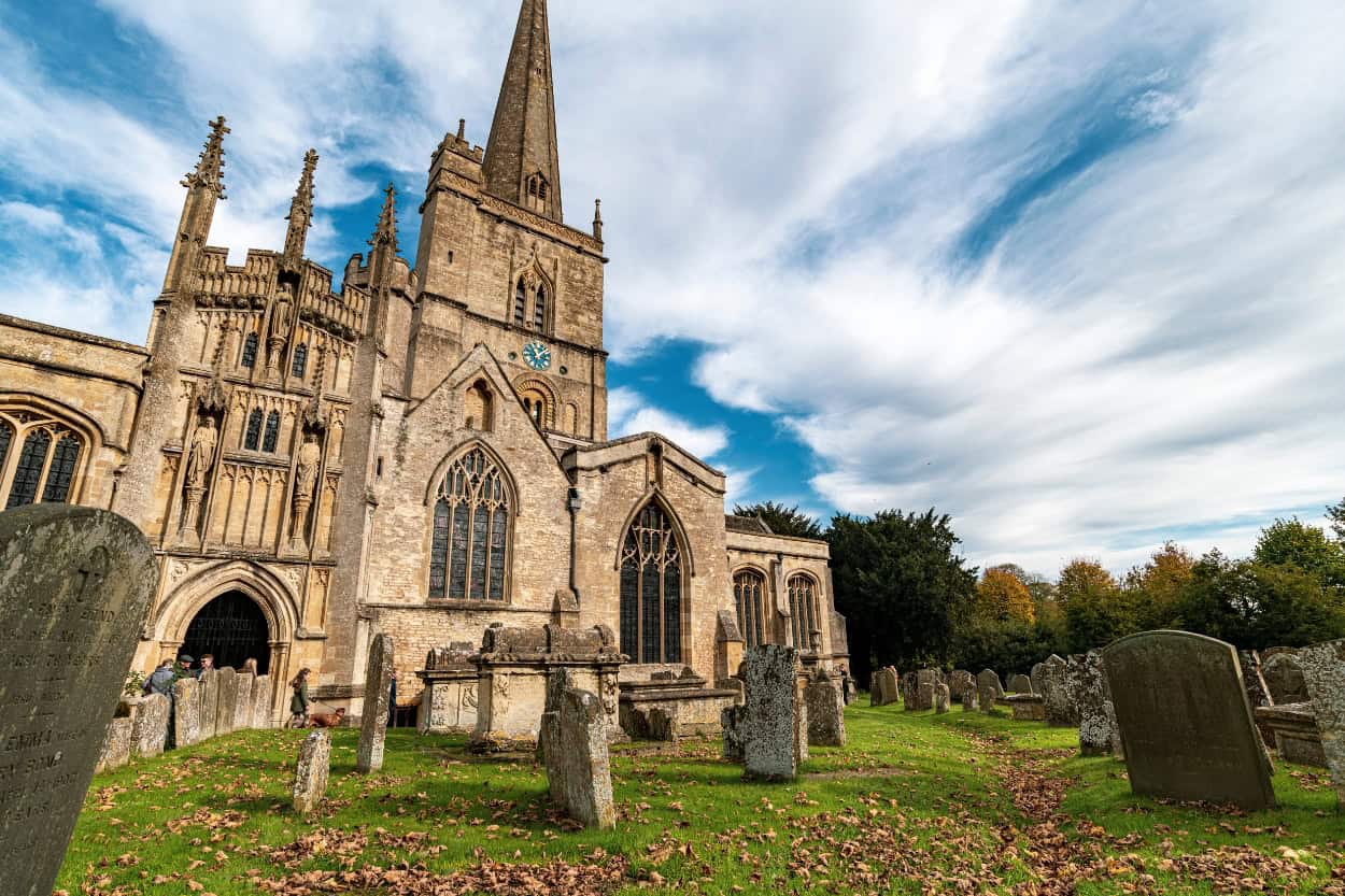 Church and cemetery in autumn walking the Cotswolds in Burford England