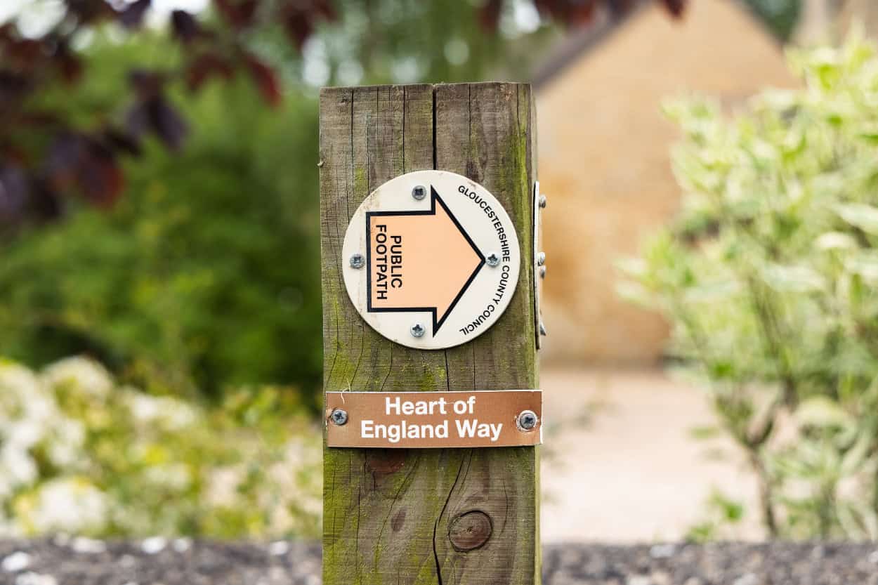 Public Footpath and Heart of England Way signpost walking the Cotswolds countryside England