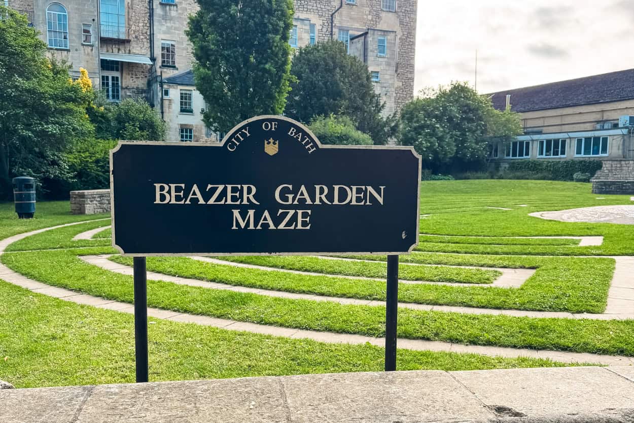 Sign for the Beazer Garden Maze with the stone maze laid out in fresh-cut grass, Bath