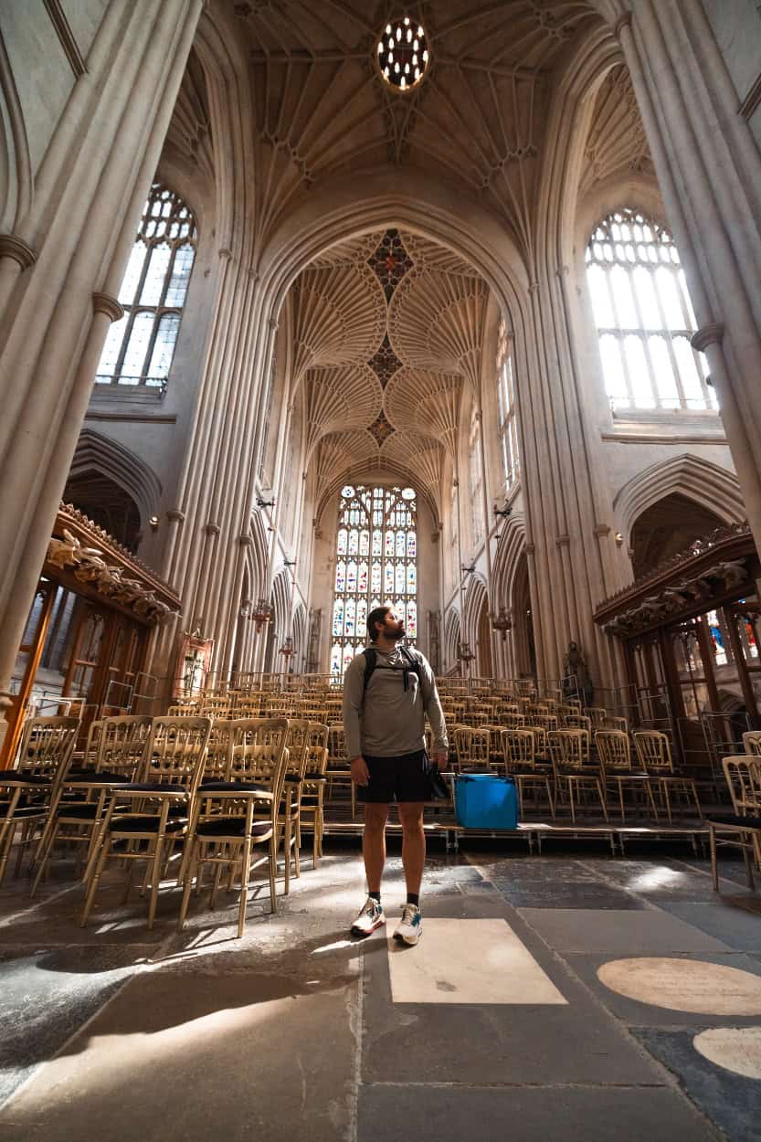 Joey standing inside Bath Abbey with light streaming through stained glass windows