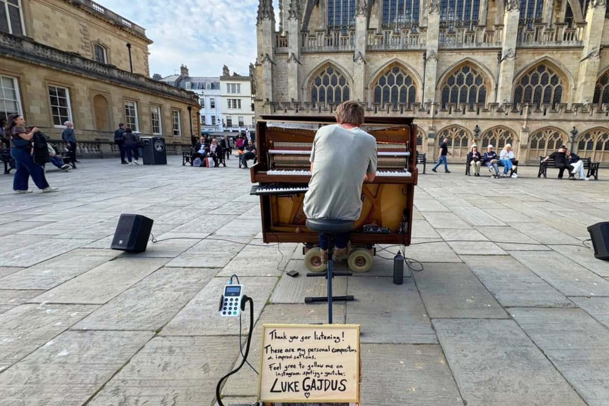 Pianist Luke Gajdus performing in Kingston Parade near Bath Abbey, Bath, England