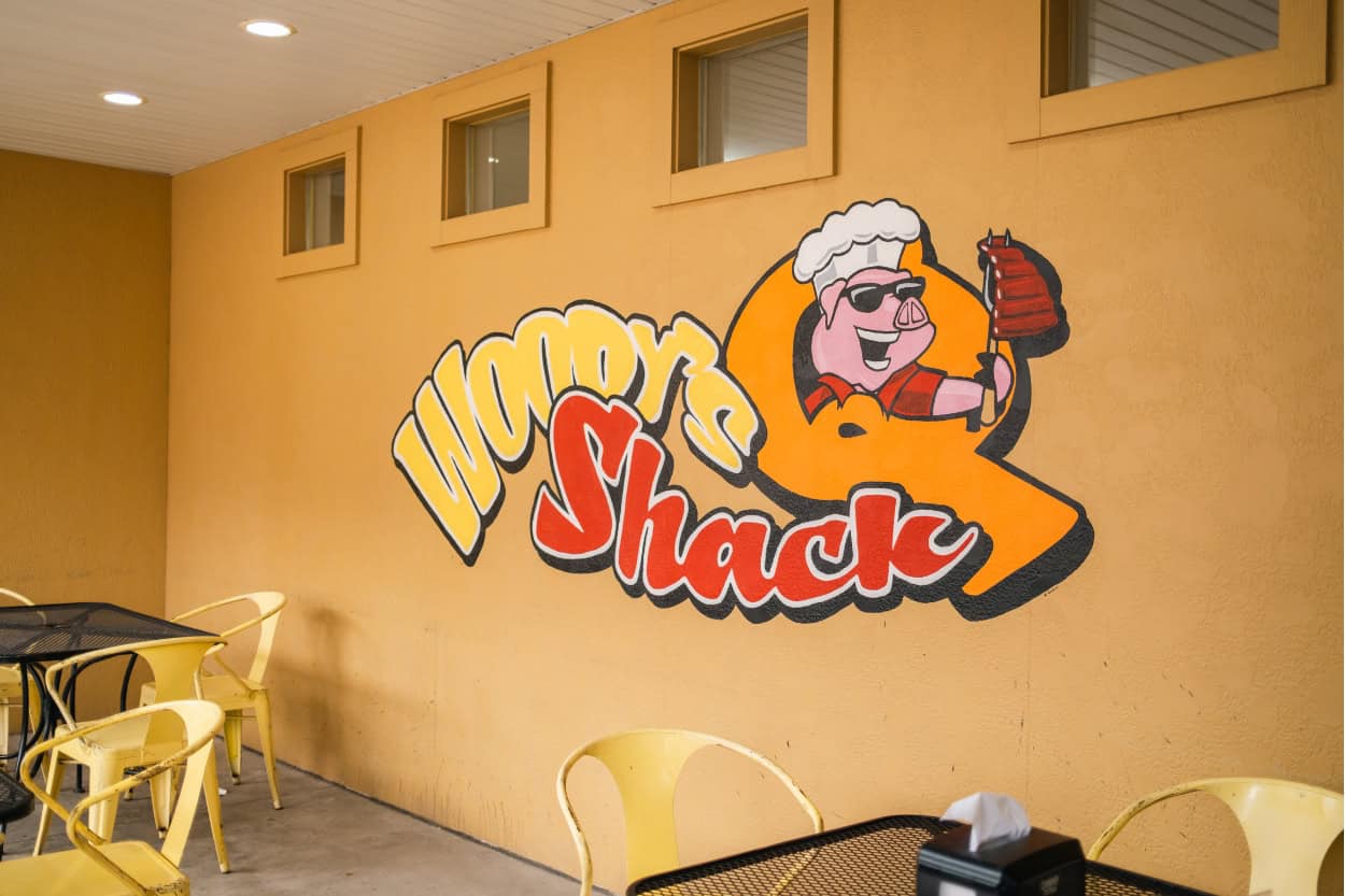 Woody's Q Shack logo painted on the patio in Alamosa, Colorado