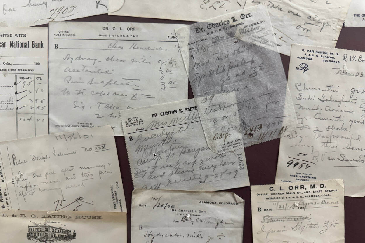 Historic notes from a bank, train depot, and restaurants from the early 1900s displayed at the Alamosa Visitor Center