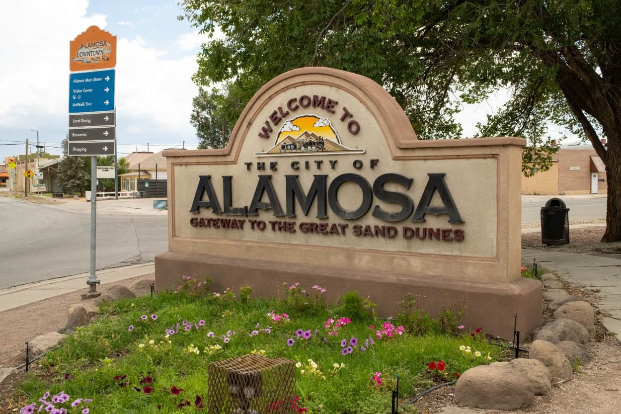 Welcome to Alamosa" sign reading gateway to the Great Sand Dunes in Colorado